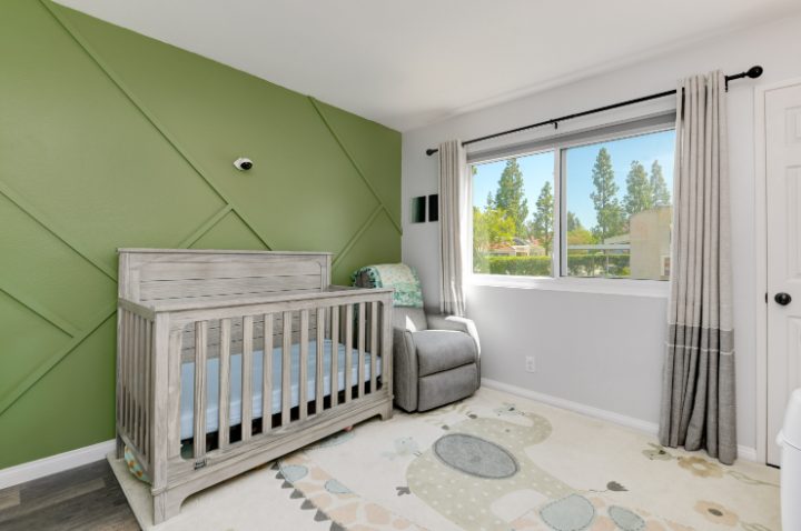 Nursery with forest-green accent wall