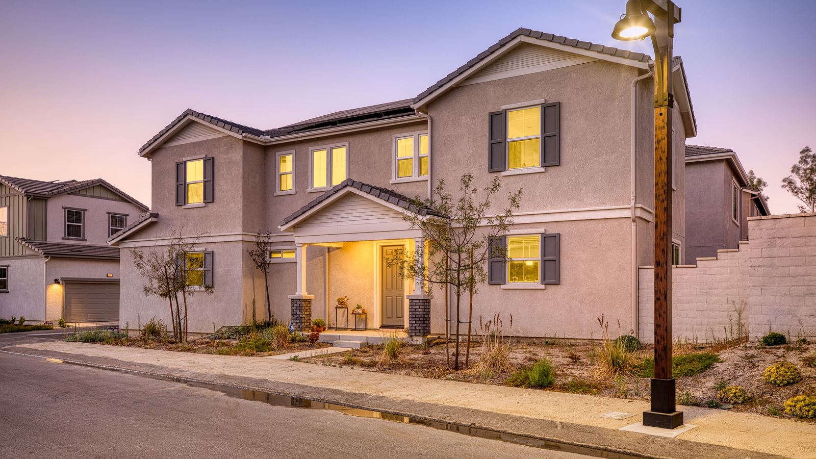 Two-story stucco home at dusk